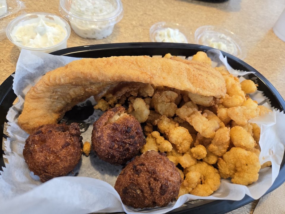 Counter service area with trays of comfort food.